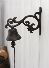 Litinový zvonek na konzolce 